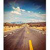 Vintage retro effect filtered hipster style image of travel forward concept background -  road in desert