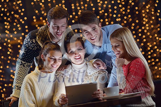 Group of happy people looking at a tablet computer Group of happy people looking at a tablet computer