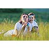 happy child and woman outdoor playing with soap bubble on meadow