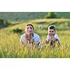 happy child and woman outdoor playing with soap bubble on meadow