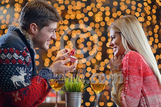 The young man gives a wedding ring gift to girl in restaurant The young man gives a wedding ring gift to girl in restaurant