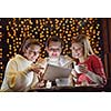 happy girls group  looking at a pc tablet in a home interior and have fun