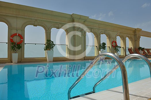 roof swimming pool at top of the hotel with blue sky in background