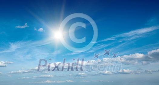 Sun with clouds in blue sky