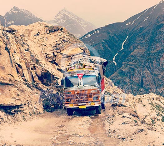 Vintage retro effect filtered hipster style travel image of Manali-Leh road in Indian Himalayas with lorry. Himachal Pradesh, India