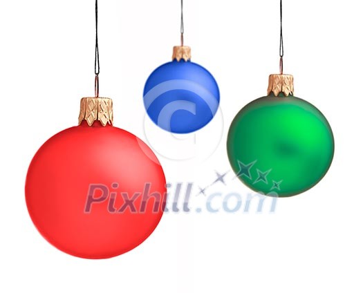 Several hanging Christmas baubles isolated on white background