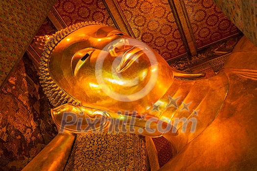 Reclining Buddha gold statue face. Wat Pho, Bangkok, Thailand Reclining Buddha gold statue face. Wat Pho, Bangkok, Thailand