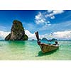 Long tail boat on tropical beach (Pranang beach) and rock, Krabi, Thailand