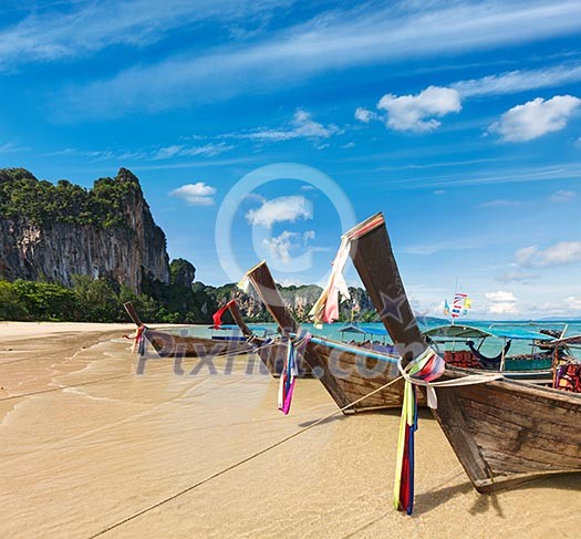 Long tail boats on tropical beach in Thailand