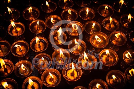 Burning candles in Tibetan Buddhist temple. Himachal Pradesh, India Burning candles in Tibetan Buddhist temple. Himachal Pradesh, India