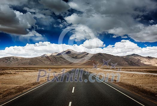 Travel forward concept background - road on plains in Himalayas with mountains and dramatic clouds. Manali-Leh road, Ladakh, Jammu and Kashmir, India Travel forward concept background - road on plains in Himalayas with mountains and dramatic clouds. Manali-Leh road, Ladakh, Jammu and Kashmir, India