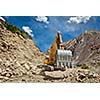 Excavator doing road construction in Himalayas. Ladakh, Jammu and Kashmir, India