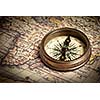 Old vintage retro compass on ancient map