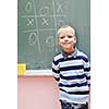 happy young boy at first grade math classes solving problems and finding solutions