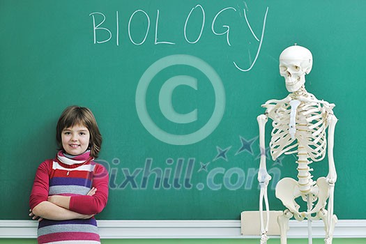 happy children group  in school classrom taking notes and learning biology and anatomy lessons with teacher