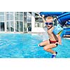 happy kids have fun on outdoor swimming pool at beautiful aquapark