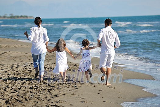 happy young family in white clothing have fun at vacations on beautiful beach happy young family in white clothing have fun at vacations on beautiful beach