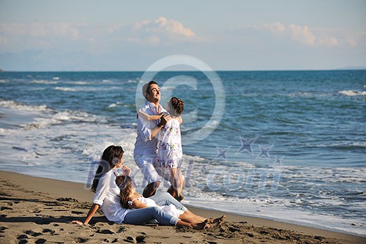 happy young family in white clothing have fun at vacations on beautiful beach happy young family in white clothing have fun at vacations on beautiful beach