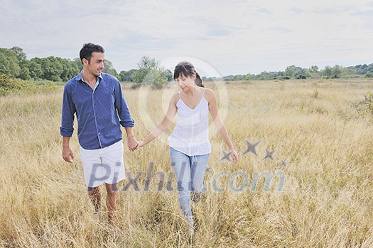 happy young couple enjoying picnic on the countryside in the field and have good time happy young couple enjoying picnic on the countryside in the field and have good time
