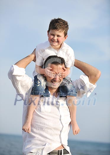happy young father and son have fun and enjoy time on beach at sunset and representing healthy family and support concept happy young father and son have fun and enjoy time on beach at sunset and representing healthy family and support concept
