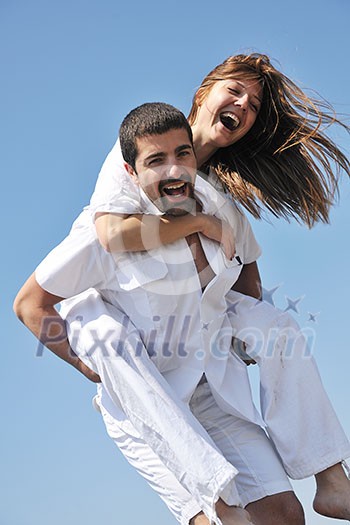 happy young couple have fun and romantic moments on beach at summer season and representing happynes and travel concept happy young couple have fun and romantic moments on beach at summer season and representing happynes and travel concept