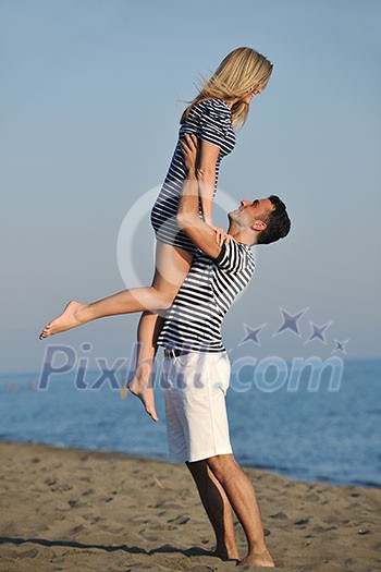 happy young couple have romantic time on beach at sunset happy young couple have romantic time on beach at sunset