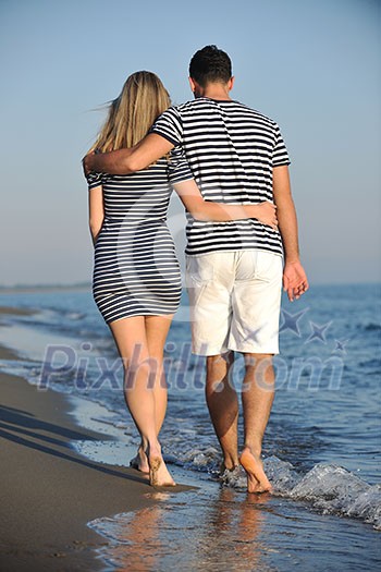 happy young couple have romantic time on beach at sunset happy young couple have romantic time on beach at sunset