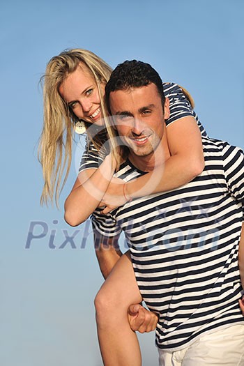happy young couple have romantic time on beach at sunset happy young couple have romantic time on beach at sunset