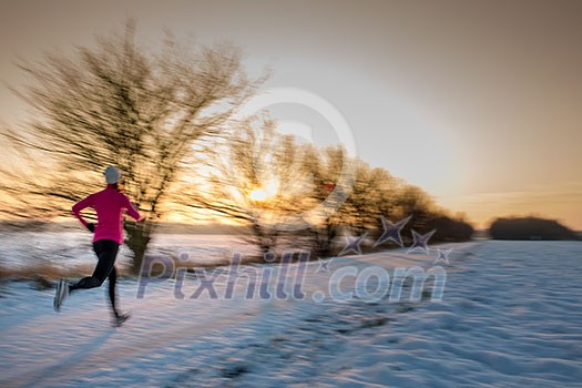 Young woman stretching while running outdoors on a cold winter evening