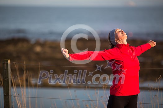 Young woman on her evening jog along the seacoast Young woman on her evening jog along the seacoast