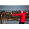 Young woman on her evening jog along the seacoast