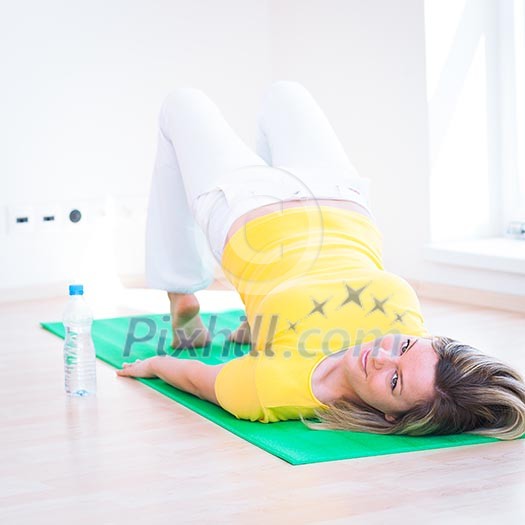 Pretty young woman doing YOGA exercise at home Pretty young woman doing YOGA exercise at home