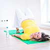 Pretty young woman doing YOGA exercise at home