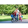 portrait of happy young family,  mother and  kids have fun in park