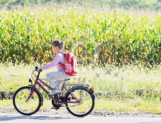 schoolgirl traveling to school on bicycle at early morning on beautiful nature schoolgirl traveling to school on bicycle at early morning on beautiful nature