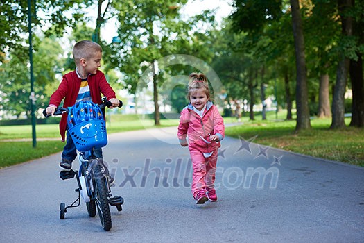 happy kids in park, boy and girl in nature with bicycle have fun happy kids in park, boy and girl in nature with bicycle have fun