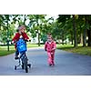 happy kids in park, boy and girl in nature with bicycle have fun