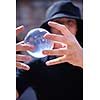 young man balancing glass globe bal with hands