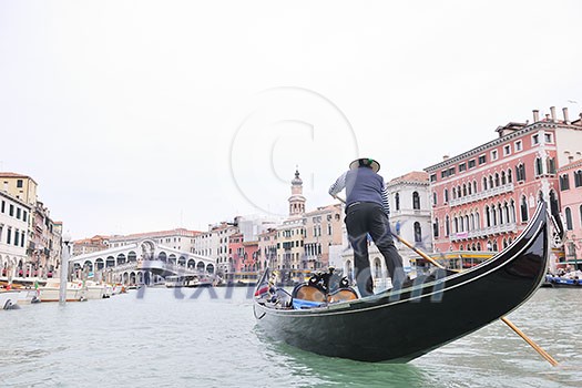 Venice - April 04: Gondoliero sailing in Venice, April 23, 2012, Venice, Italy. Grand Channel located in Venice - city on Italian islands and is famous for its gondola drivers coordinated by Guild Venice - April 04: Gondoliero sailing in Venice, April 23, 2012, Venice, Italy. Grand Channel located in Venice - city on Italian islands and is famous for its gondola drivers coordinated by Guild