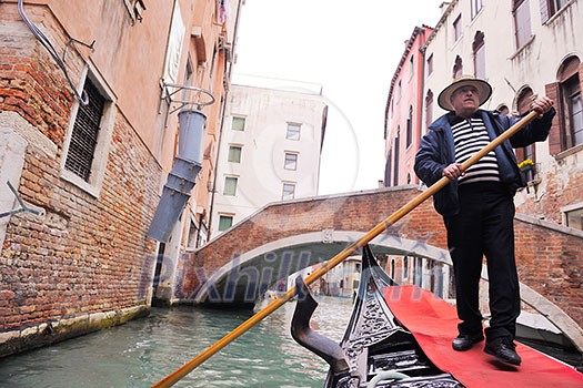 Venice - April 04: Gondoliero sailing in Venice, April 23, 2012, Venice, Italy. Grand Channel located in Venice - city on Italian islands and is famous for its gondola drivers coordinated by Guild Venice - April 04: Gondoliero sailing in Venice, April 23, 2012, Venice, Italy. Grand Channel located in Venice - city on Italian islands and is famous for its gondola drivers coordinated by Guild