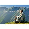 healthy young man practice yoga in height mountain at early morning and sunrise