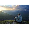 healthy young man practice yoga in height mountain at early morning and sunrise