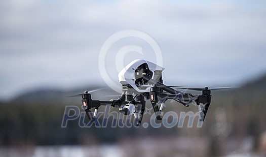 Flying drone with camera shot from side