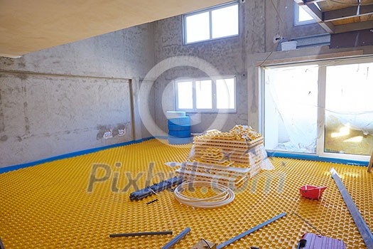 yellow underfloor heating posed in a under construction building yellow underfloor heating posed in a under construction building