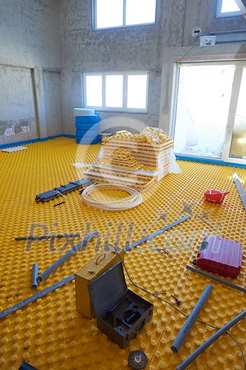 yellow underfloor heating posed in a under construction building yellow underfloor heating posed in a under construction building