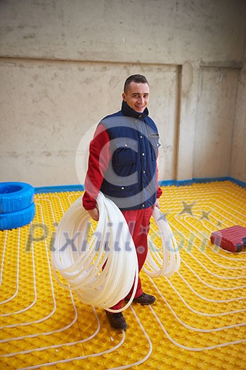 grouo of workera installing underfloor heating and colling in modern home grouo of workera installing underfloor heating and colling in modern home