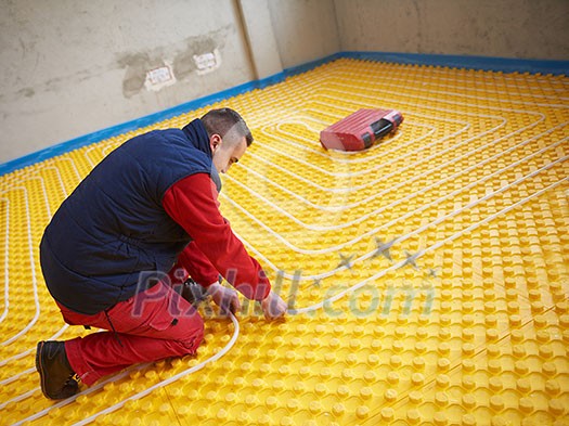 grouo of workera installing underfloor heating and colling in modern home grouo of workera installing underfloor heating and colling in modern home