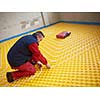 grouo of workera installing underfloor heating and colling in modern home