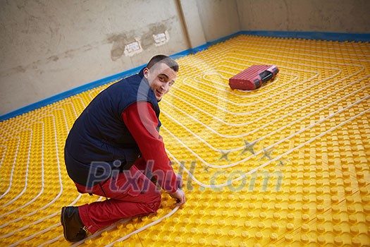 grouo of workera installing underfloor heating and colling in modern home grouo of workera installing underfloor heating and colling in modern home