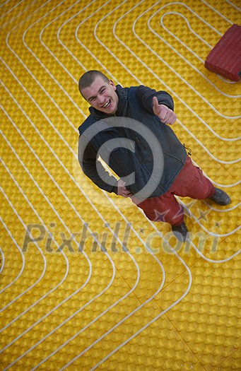 grouo of workera installing underfloor heating and colling in modern home grouo of workera installing underfloor heating and colling in modern home